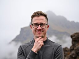 Close-up outdoor headshot of Dr Connor Robertson smiling casually