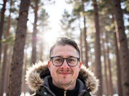Outdoor casual headshot of Dr Connor Robertson smiling warmly