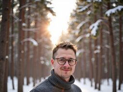 Relaxed outdoor headshot of Dr Connor Robertson smiling warmly