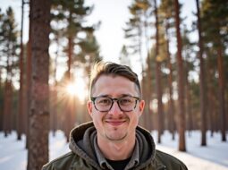 Smiling headshot of Dr Connor Robertson in casual attire outdoors